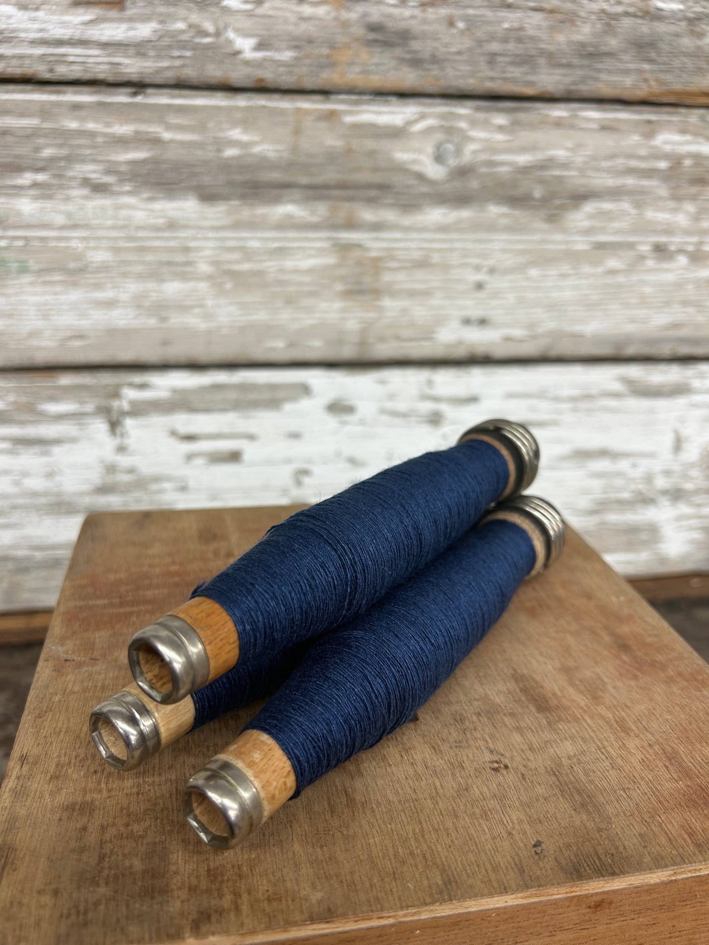 Dark Blue Yarn Quill wrapped in deep blue thread with wooden and metal ends. A unique handmade writing tool, perfect for calligraphy and decor.