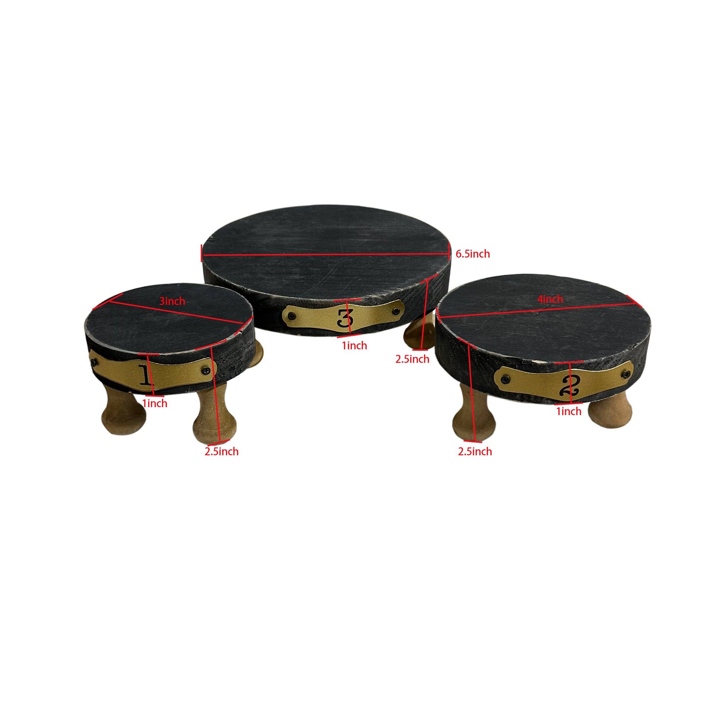 Set of 3 black round display risers made of solid wood with numbered brass plates. Sturdy design with wooden legs, ideal for showcasing decor items.