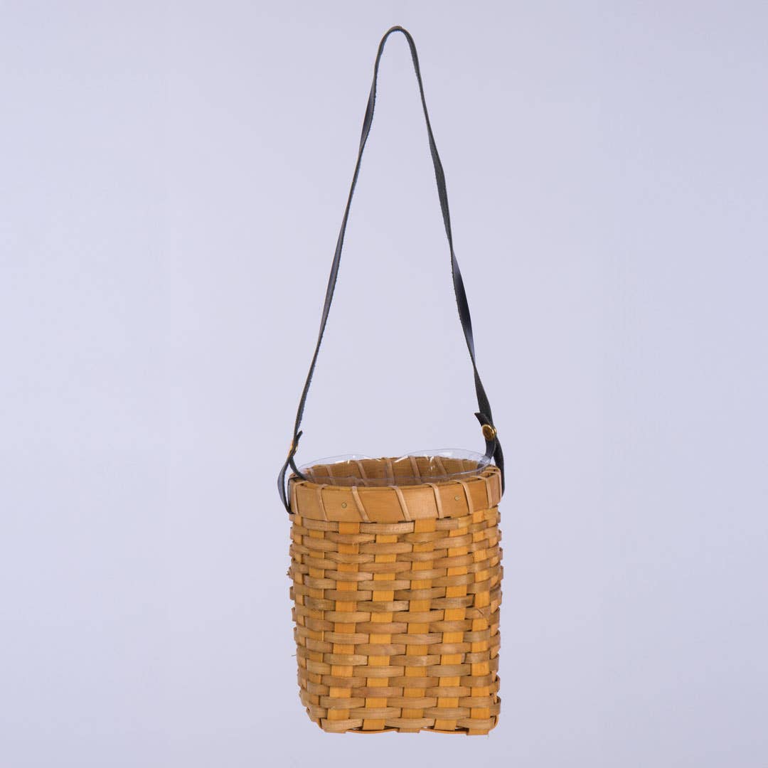 Oval Chipwood Hanging Planter with a long leather strap. Lightweight and compact, perfect for adding a rustic touch to home decor.