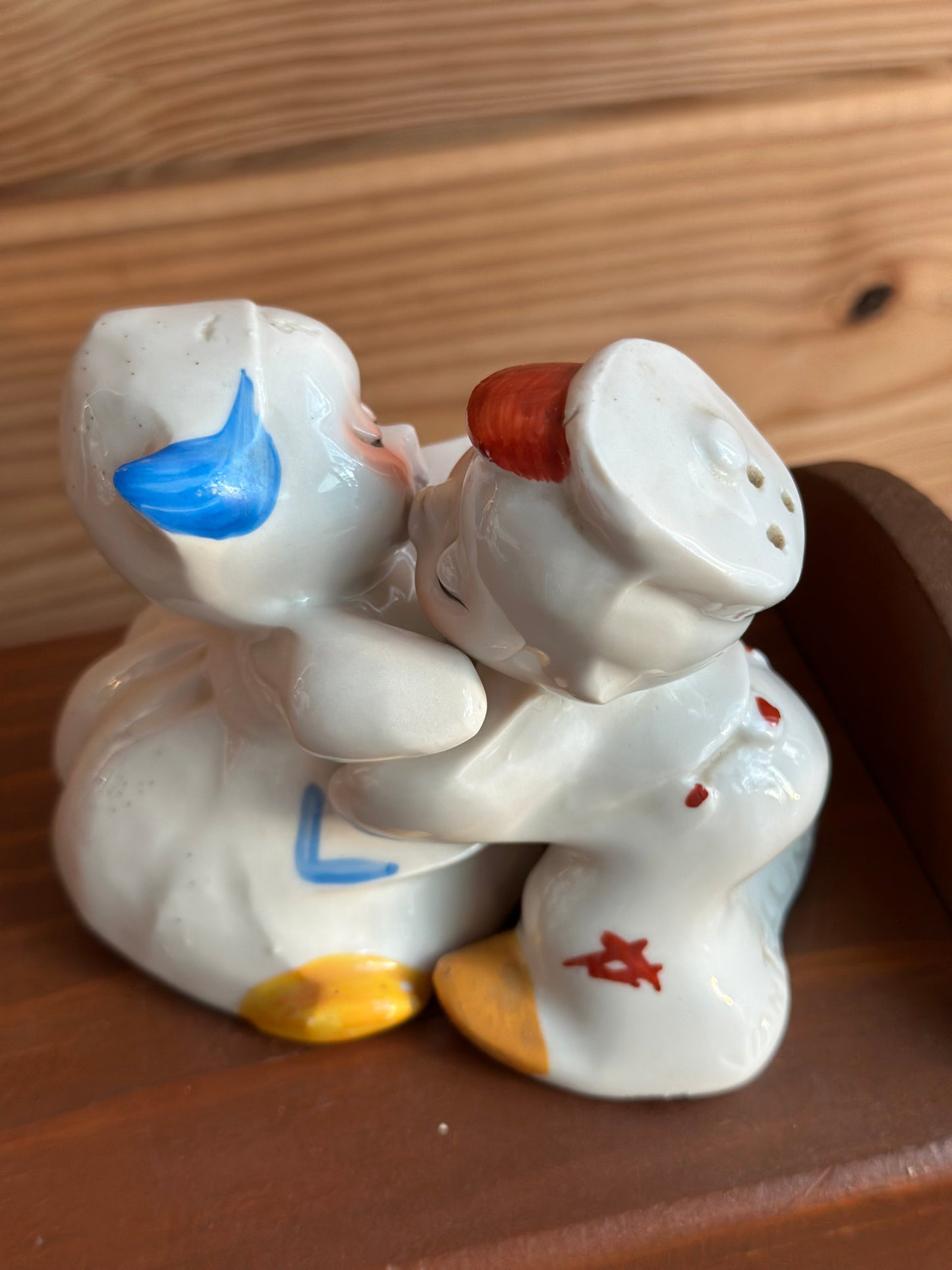 Hugging ceramic baby salt and pepper shakers with magnetic connection, featuring delicate hand-painted accents. A unique and playful addition to any dining setup.