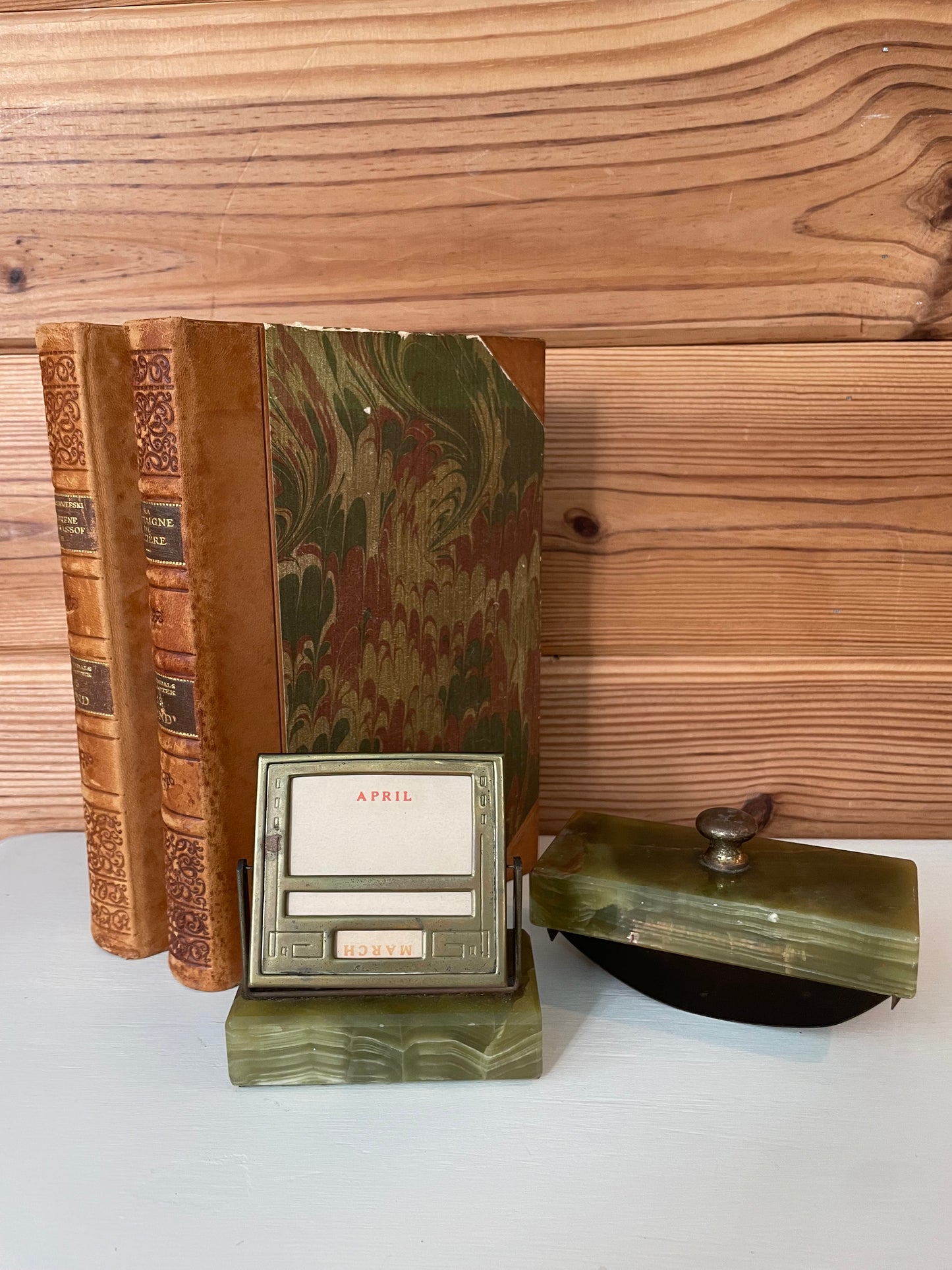 Elegant green marble perpetual calendar with an ink blotter, displayed alongside antique books for a timeless office aesthetic.