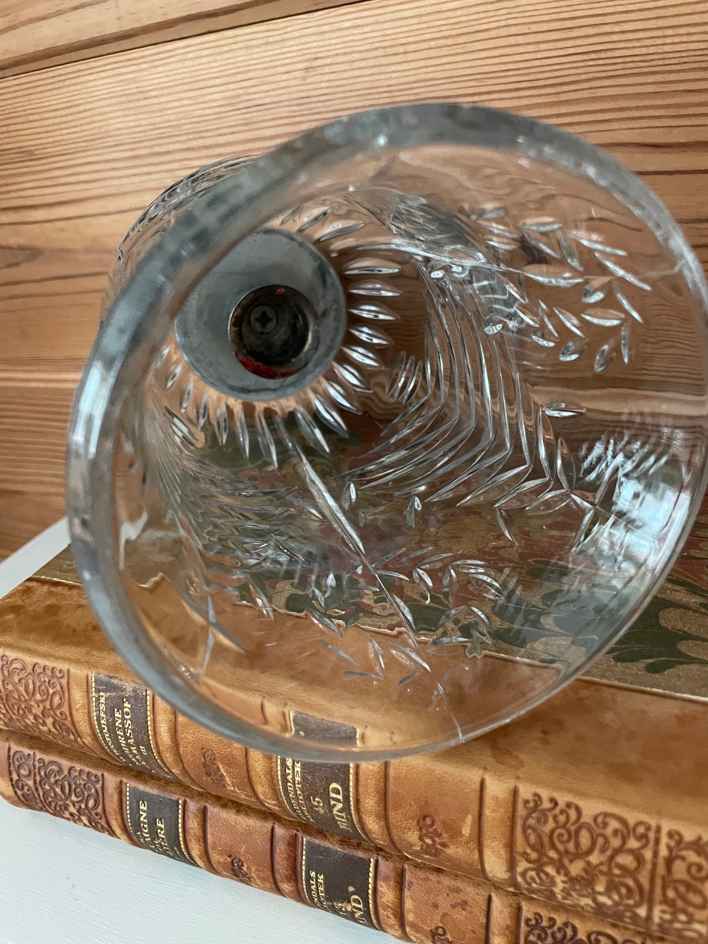 Bottom view of a vintage glass hurricane cloche, highlighting its detailed glasswork and hollow interior. A versatile decorative piece.