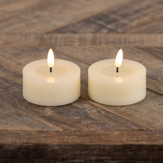 Set of 2 oversized tealight candles with a realistic 3D flame effect, placed on a rustic wooden surface. Perfect for home decor and ambiance.