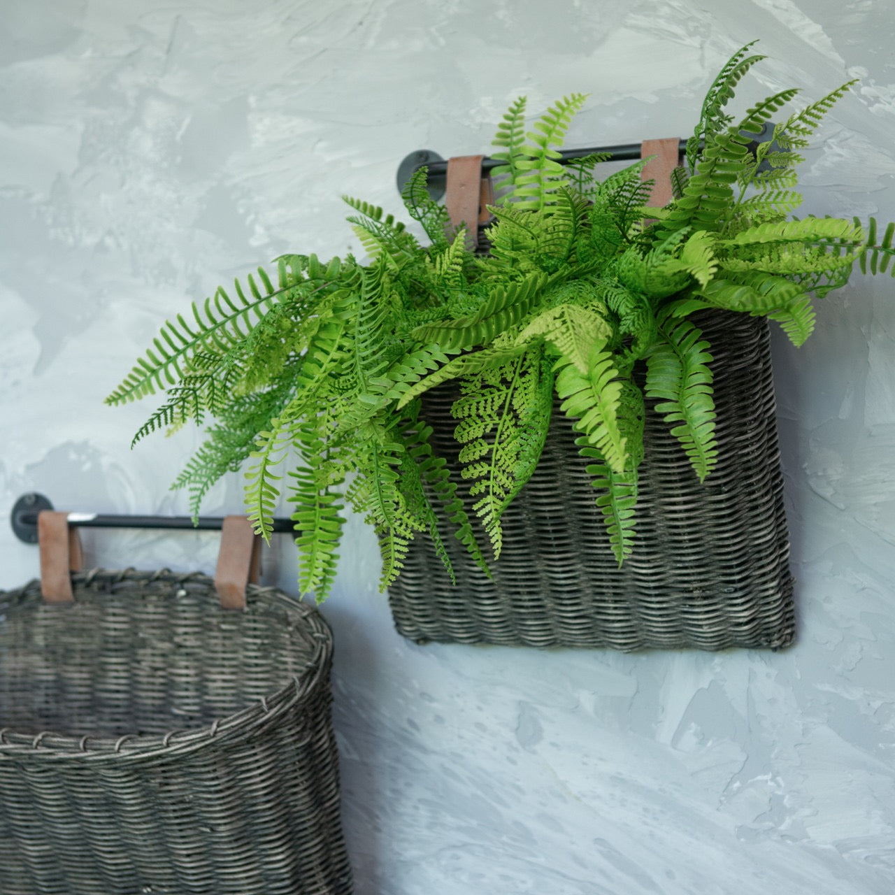 Vibrant faux Sword Fern & Cedar Bush in a woven wall basket. A durable and lifelike artificial plant for stylish home decor.