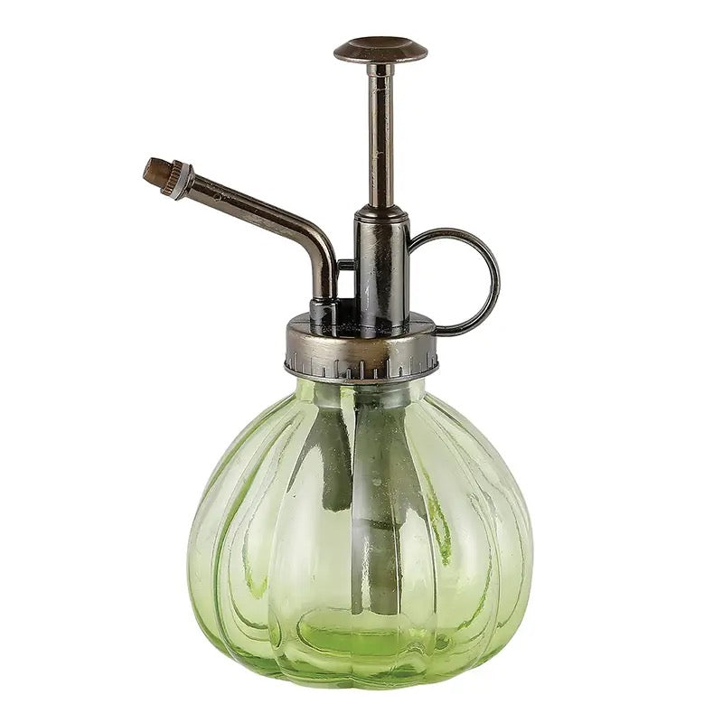 Green glass plant mister with vintage-style brass pump, ideal for watering indoor plants and succulents. Perfect for home and garden decor.