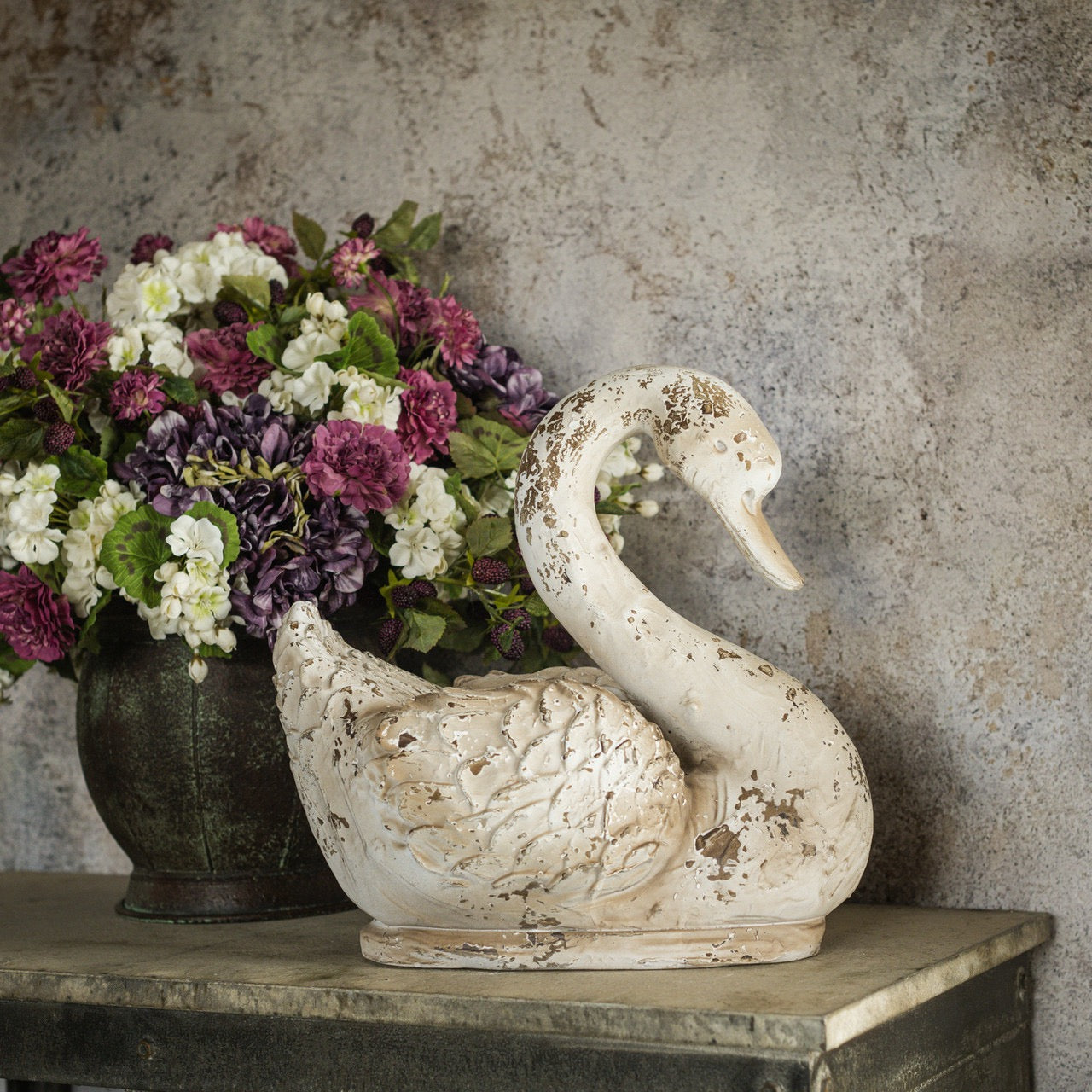 Elegant textured swan sculpture with a distressed white finish, adding vintage charm to home decor. Perfect for enhancing rustic or shabby chic interiors.