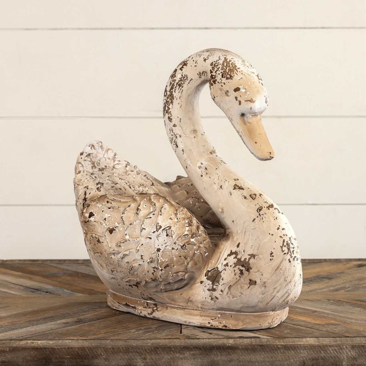 Graceful swan statue with intricate feather details and an antique-style finish, ideal for home and garden decor. A timeless decorative accent piece.