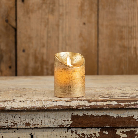 4-inch gold pillar moving flame LED candle on a rustic wooden surface. Features a realistic flickering flame effect, perfect for home decor.