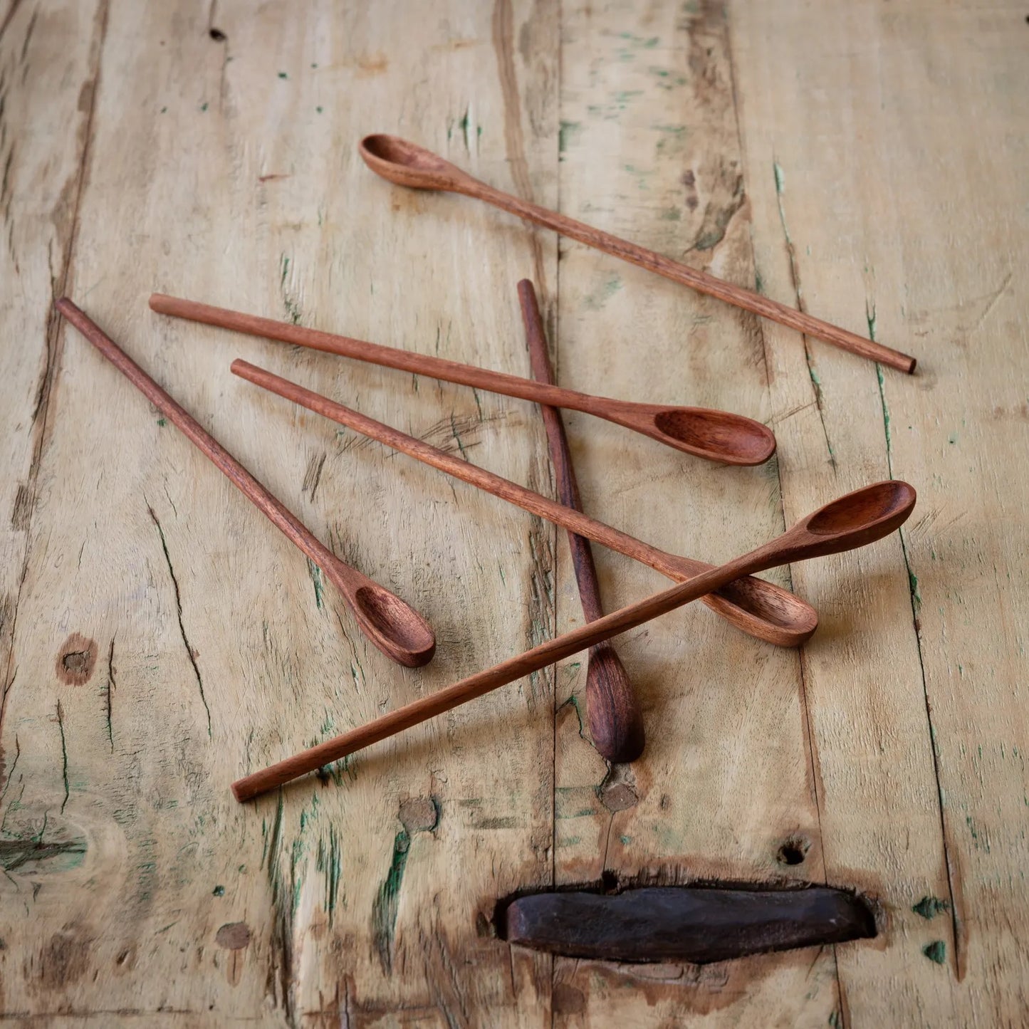 Set of 6 wooden ice tea spoons with a long, slender design, displayed on a rustic wooden surface. Ideal for stirring beverages and desserts.