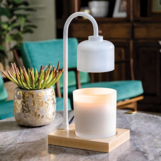 White & Wood Arched Candle Warmer Lamp elegantly placed on a marble table, creating a cozy ambiance in a stylish home setting.
