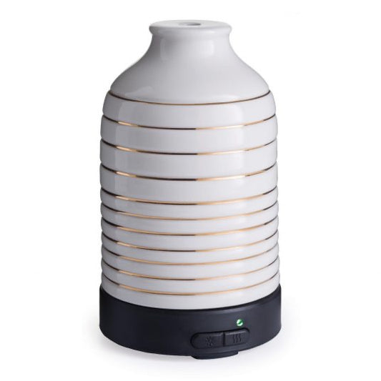 Serenity Ultra Sonic Diffuser with a sleek white ceramic design and gold accents, featuring a black base with control buttons for home fragrance.