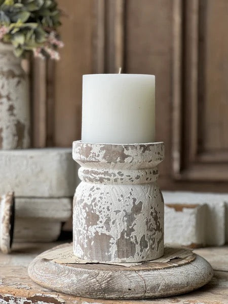 Lindhurst Pillar Holder 6 inch with distressed natural wood finish, holding a white pillar candle. Features a rustic design with a metal candle pan.