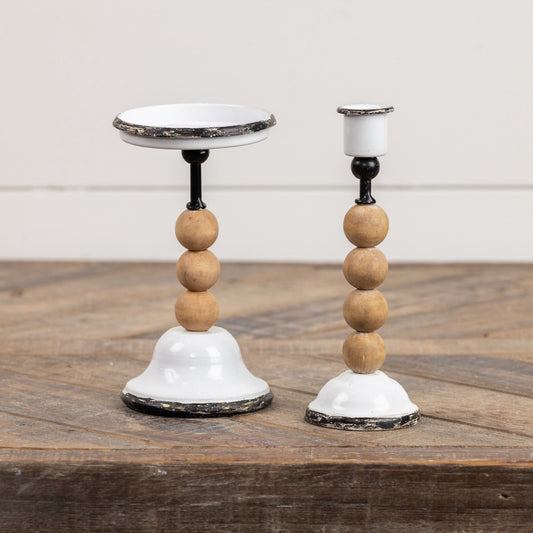 Set of 2 combination taper and pillar candle holders with distressed white metal and wooden bead accents, perfect for rustic home decor.
