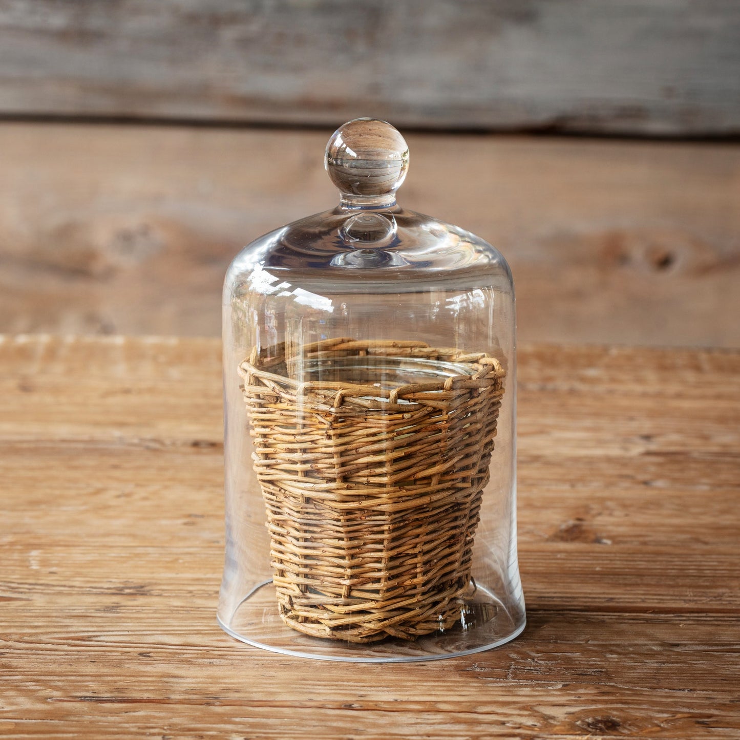 Elegant 7.5-inch glass cloche covering a woven basket, ideal for enhancing home decor and protecting delicate items in a stylish way.