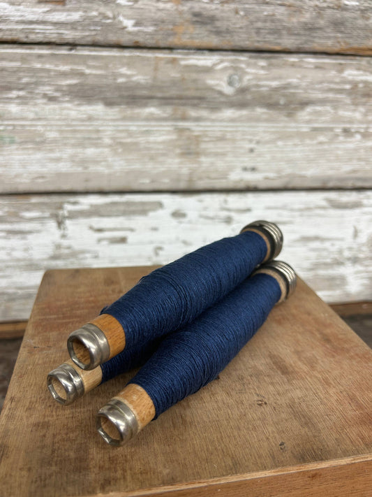 Dark Blue Yarn Quill wrapped in deep blue thread with wooden and metal ends. A unique handmade writing tool, perfect for calligraphy and decor.