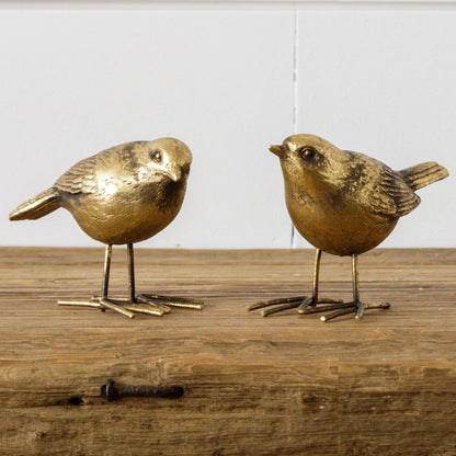 Brass bird figurines crafted from resin and iron, featuring intricate detailing. Perfect for home decor, these decorative birds add elegance to any space.