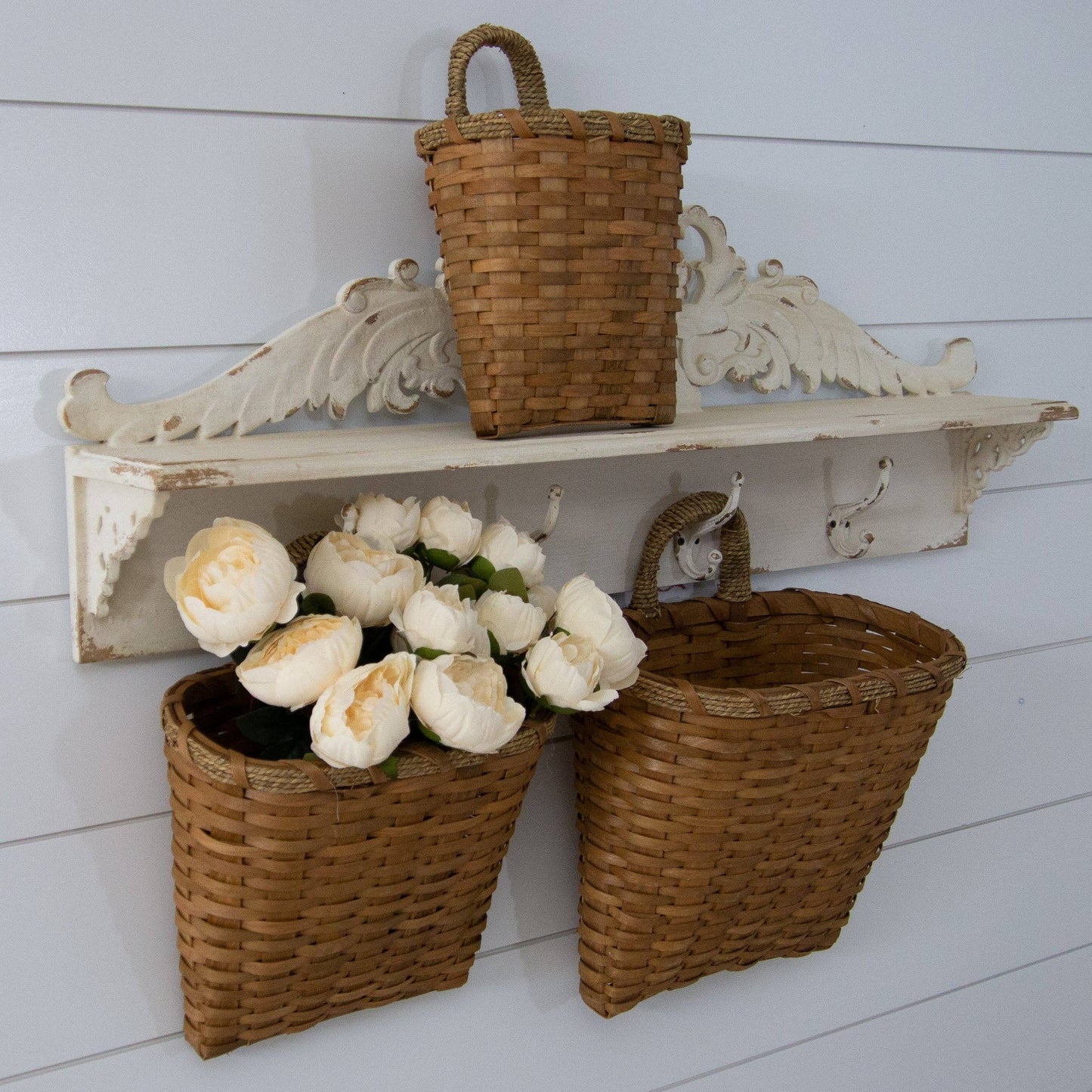 Rustic chipwood hanging baskets with woven handles, set of 3 in varying sizes. Perfect for wall decor and organizing essentials stylishly.