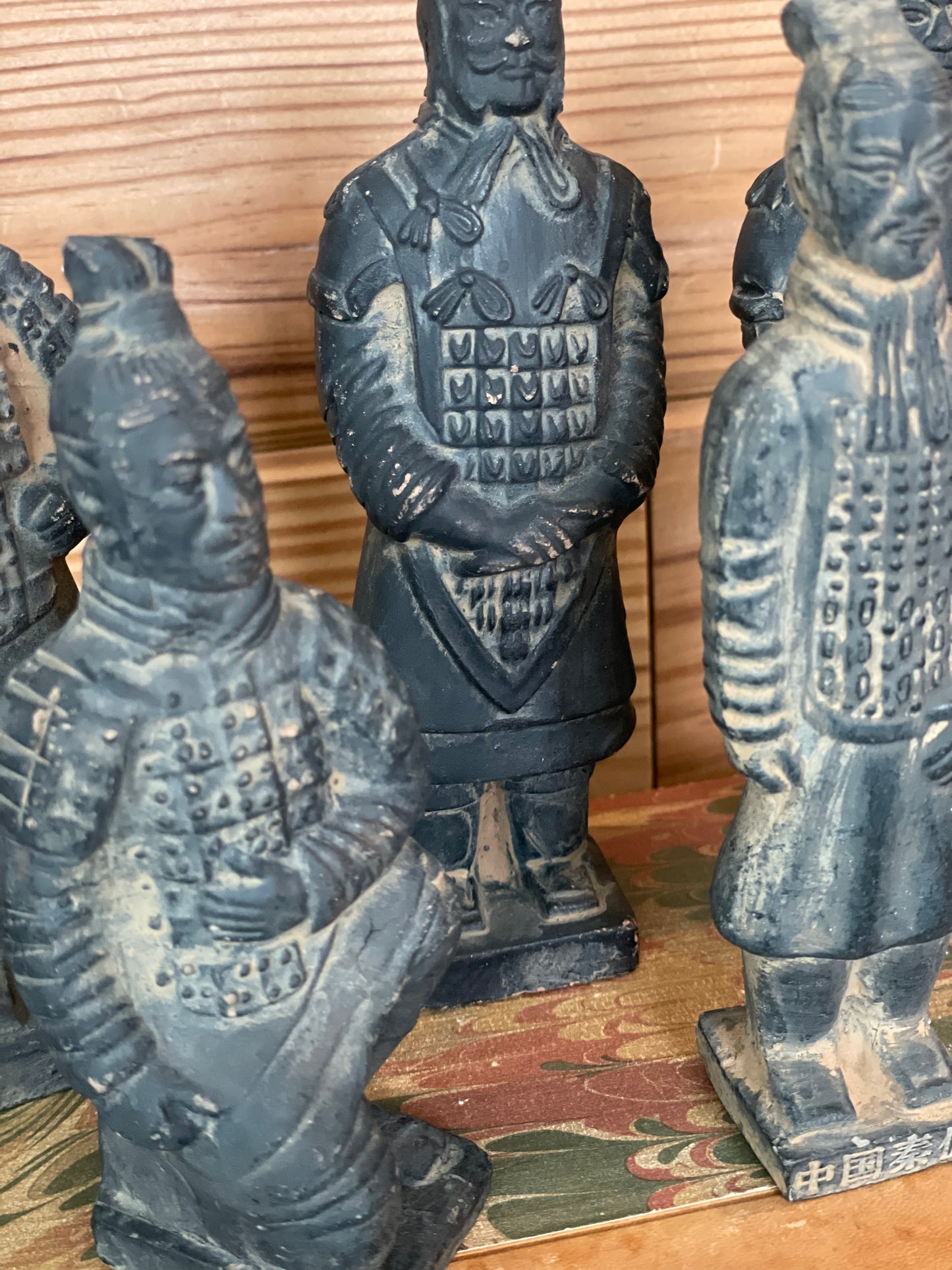 Close-up of vintage terracotta Chinese warrior figurines, highlighting intricate hand-painted details. A timeless decorative piece celebrating ancient history.