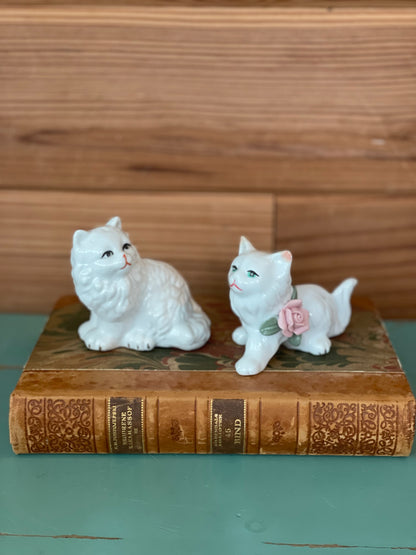 Vintage ceramic cat figurines set of two, featuring intricate details and a timeless design. Perfect for collectors and vintage home decor enthusiasts.