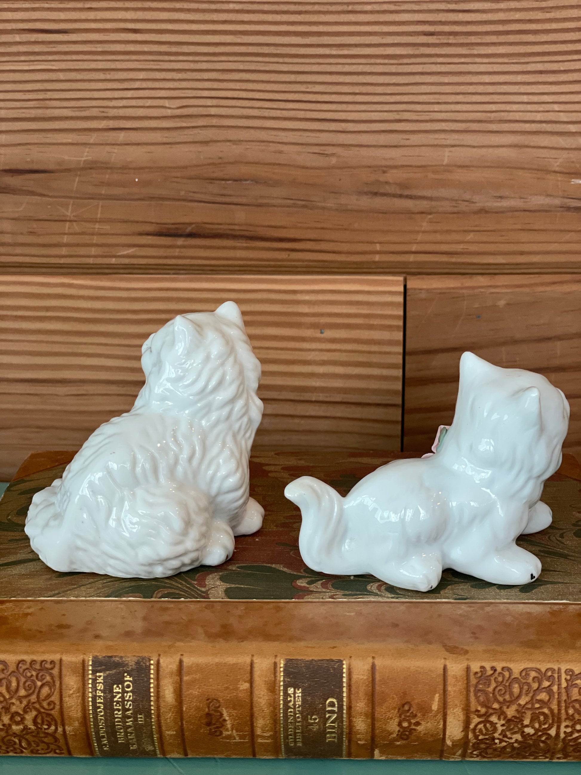 Rear view of vintage ceramic cat figurines showcasing fine craftsmanship. Ideal for home decor and antique collectors.