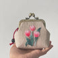 Tulip embroidered beige coin purse with vintage metal clasp and red string detail. Handmade linen pouch featuring pink tulip floral embroidery.