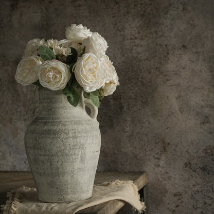 Elegant Cream Rose Bush - 17.25" arranged in a rustic vase. A lifelike artificial floral display ideal for vintage-inspired home decor.