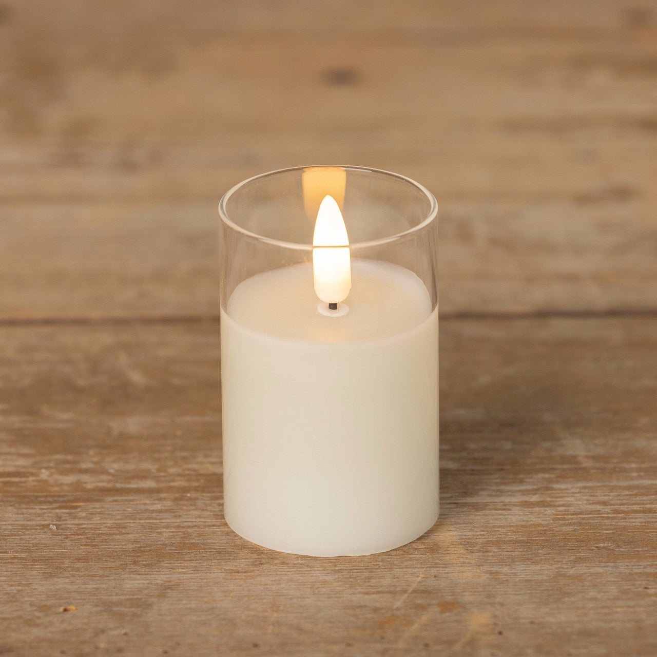 Minimalist 3-inch Glass 3D Flame Candle with a lifelike flickering flame, set on a rustic wooden surface for a cozy ambiance.