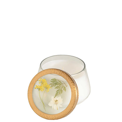 Rosy Rings Honey Tobacco floral scented candle in a glass jar with a decorative gold lid featuring pressed flowers. Hand-poured with a 70-hour burn time.