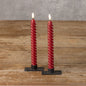 Set of 2 red 3D flame twist taper candles, 9.5 inches tall, with a unique spiral design and realistic flickering glow. Perfect for home decor and ambiance.