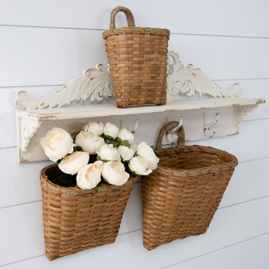 Set of 3 hanging chipwood baskets with woven handles, displayed on a white vintage-style wall shelf. Ideal for home decor and storage.