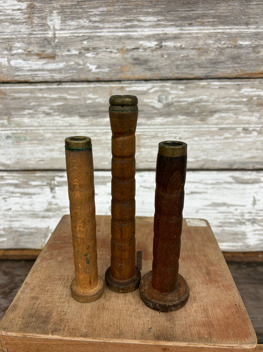Set of 3 vintage wooden spools from 1800s textile mills, featuring aged patina and unique textures. Ideal for décor, crafting, or collectors.